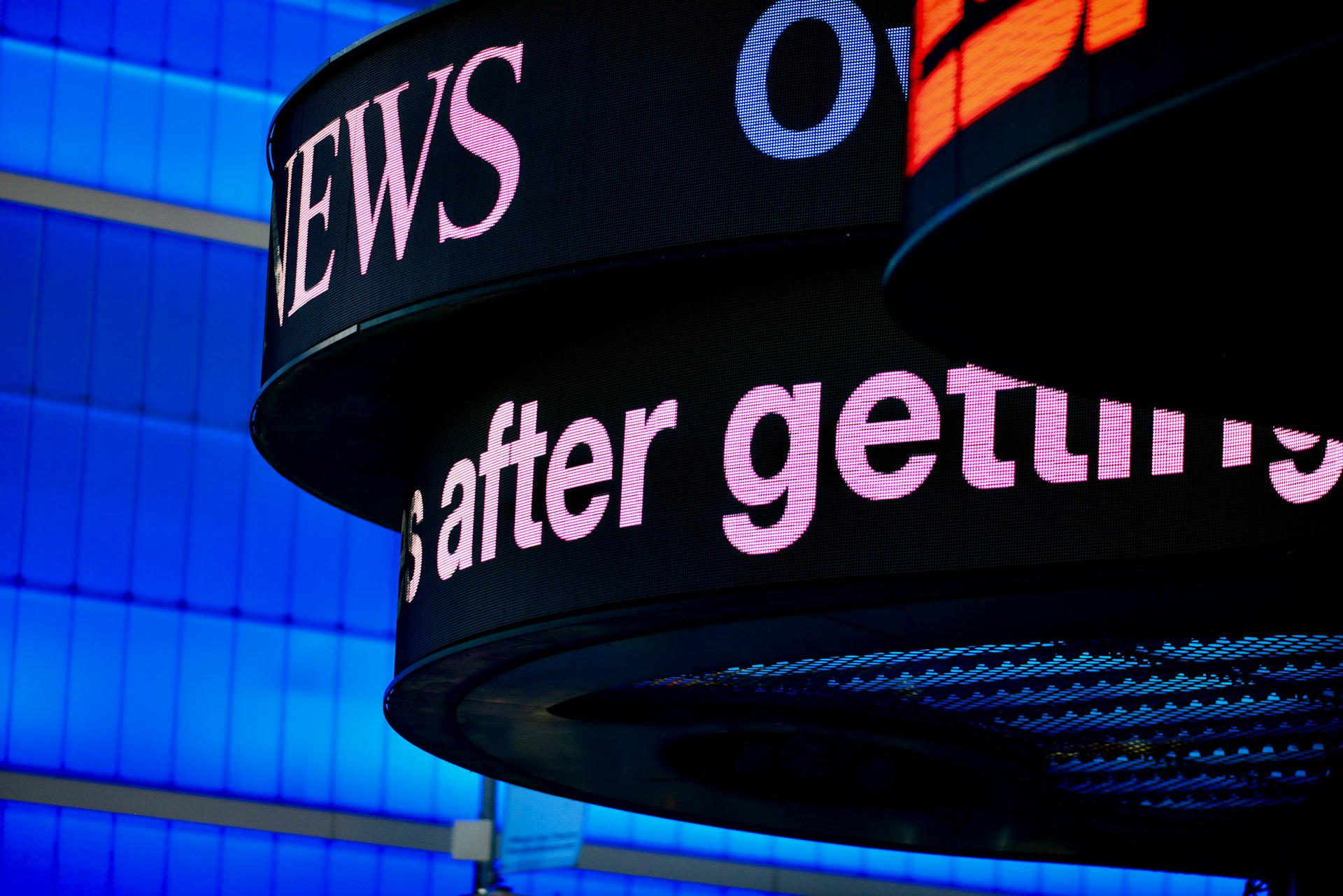 a close up of a sign with a building in the background